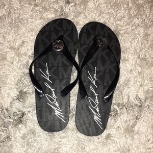 Mochael Kors black flip flops